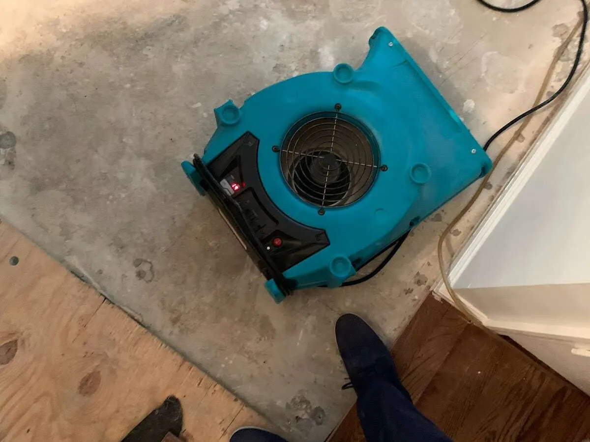 Air mover drying subfloor during Commercial Water Damage Restoration in Archer Lodge